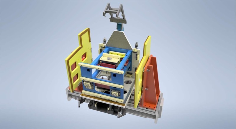 CAD render of a welding fixture with colour-coded location plates and toggle clamps on extrusion base rails